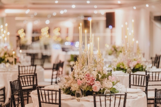 Ceremony arch with white florals on event yacht deck