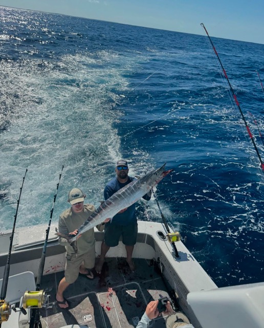 Family enjoying a fishing trip on calm water near Miami