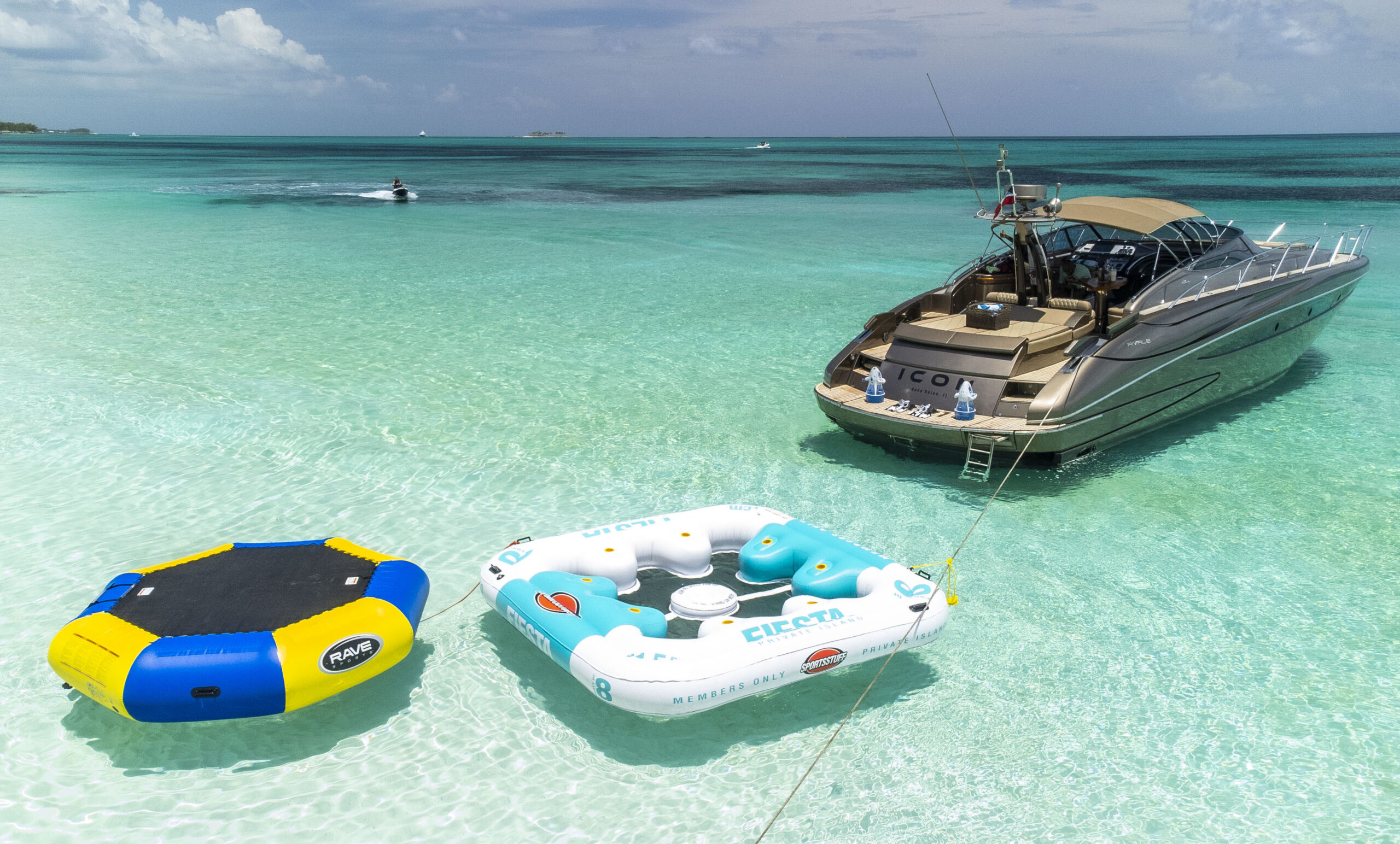 Guests relaxing on the bow of a yacht near Bimini with clear water